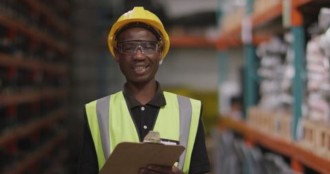 Confident African American Male Warehouse Worker Holding Clipboard