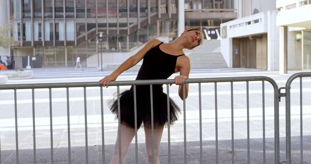 Ballet Dancer Stretching on Metal Barrier in Urban Environment - Download Free Stock Images Pikwizard.com
