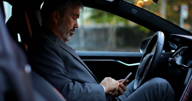 Businessman using smartphone in luxury car during commute - Download Free Stock Images Pikwizard.com