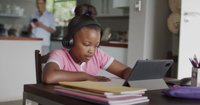 Focused Girl with Headphones Studying on Tablet at Home - Download Free Stock Images Pikwizard.com