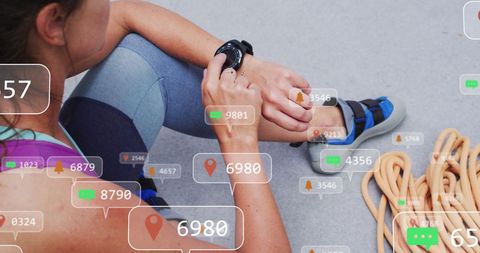 Woman in fitness gear with smartwatch tracking social media