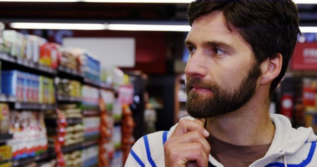 Handsome man shopping in grocery section of supermarket