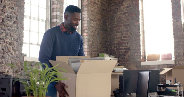 Young Professional Unpacking Box at New Office - Download Free Stock Images Pikwizard.com