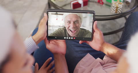 Couple Enjoying Virtual Christmas Call with Friend
