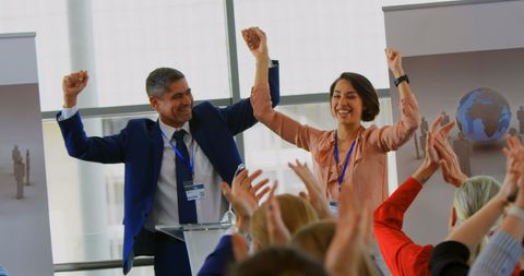 Joyful business team celebrating success at professional seminar