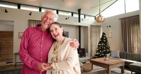 Senior Couple Celebrating Christmas in Cozy Modern Living Room