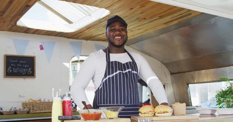 Smiling Chef Preparing Delicious Burgers in Food Truck - Download Free Stock Images Pikwizard.com