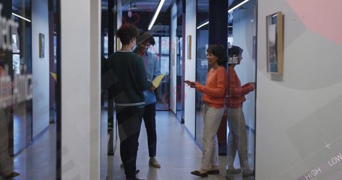 Coworkers Analyzing Report in Modern Business Corridor - Download Free Stock Images Pikwizard.com