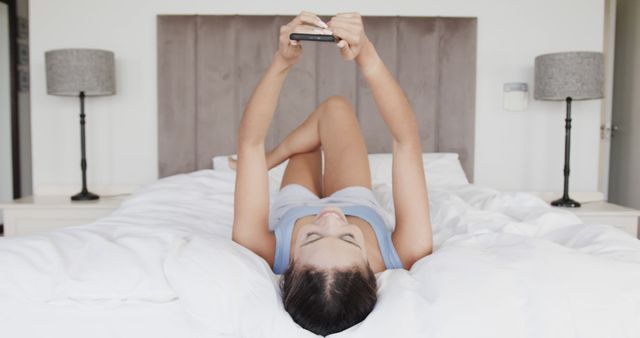 Woman Lying in Bed Using Smartphone Relaxing at Home - Download Free Stock Images Pikwizard.com