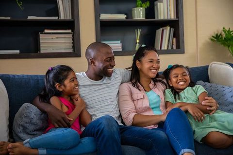 Happy Family Relaxing on Comfortable Living Room Sofa