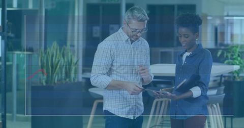 Coworkers Analyzing Data on Digital Tablet in Modern Office Setting