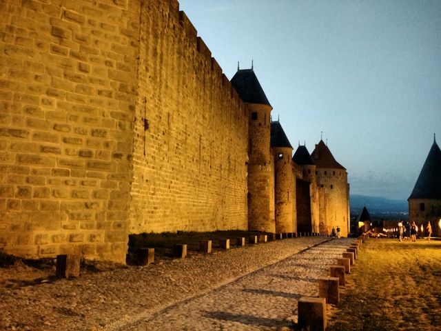 Historic Castle Walls at Dusk with Illuminated Fortress - Download Free Stock Photos Pikwizard.com