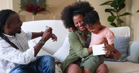 Family Celebrates Child's Birthday at Home with Joy and Laughter