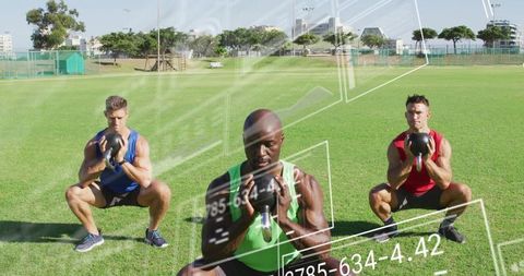 Three athletes squatting while holding kettlebells on grass with numeric data overlay