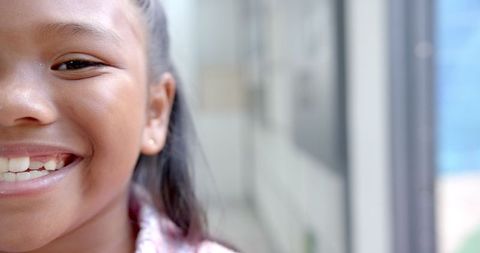 Joyful Child Smiling in School Hallway