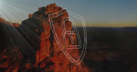 Digital security overlay on desert cliff at dusk