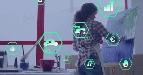 Artist in Studio Painting with Eco-conscious Icons Highlighting Sustainability