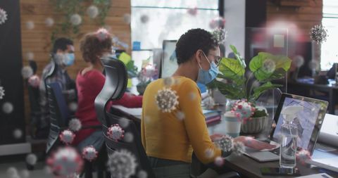 Pandemic Office Safety: Employees Sanitizing Workstations from COVID-19