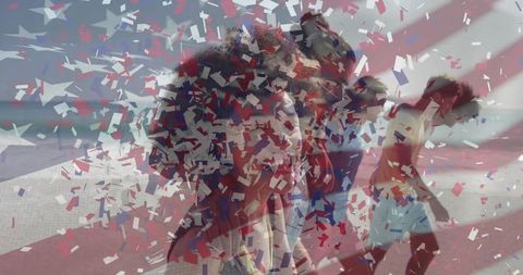 Friends celebrating by seaside with red, white, blue confetti