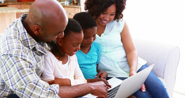 Happy African American family spending time together on laptop at home - Download Free Stock Images Pikwizard.com