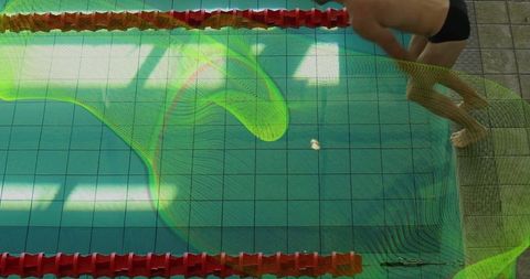 Swimmer preparing to dive in swimming pool with lane dividers