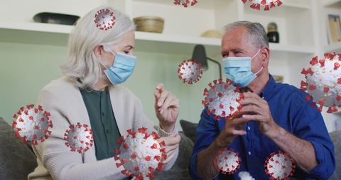 Senior couple wearing masks amidst covid-19 virus simulation