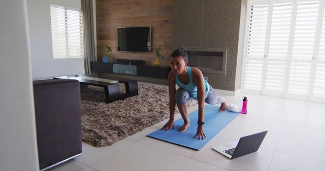 Young Woman Practicing Yoga at Home on Mat with Laptop for Virtual Class - Download Free Stock Images Pikwizard.com
