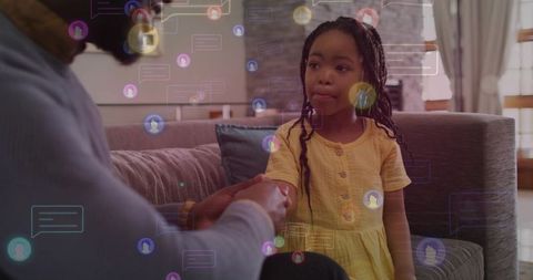 Parent reaching to hold child's hands while floating chat bubbles symbolizing guidance