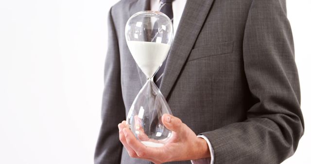 Businessman Holding Hourglass Symbolizing Time Management and Deadlines - Download Free Stock Images Pikwizard.com