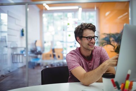 Young Professional Engaged in Office Work on Computer