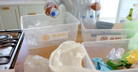 Senior Woman Segregating Household Waste for Recycling at Home