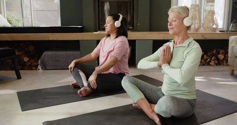 Seniors Enjoying Meditation with Headphones at Home