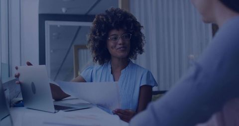 Businesswoman Reviewing Charts in Modern Office Space