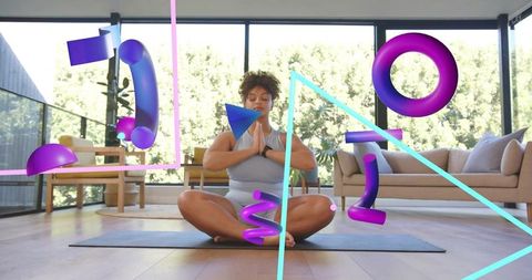 Woman practicing mindful meditation at home with fitness tracker and holographic ar graphics