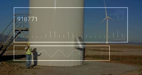 Engineer inspecting wind turbine with digital interface overlay
