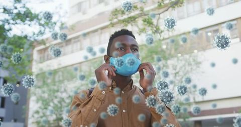 African American Man Wearing Face Mask Amid COVID-19 Cells