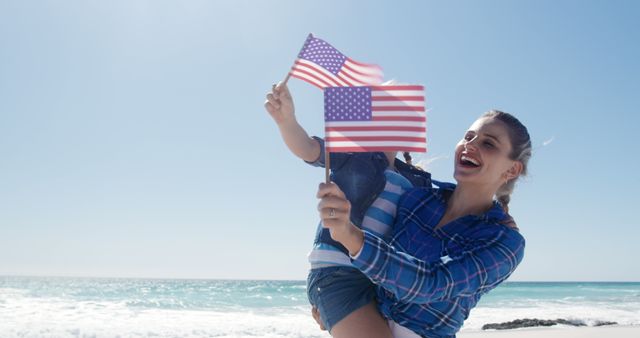 Mother and Child Celebrating with American Flags at Beach - Download Free Stock Images Pikwizard.com