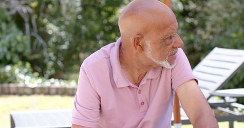 Senior man relaxing in tranquil backyard garden setting