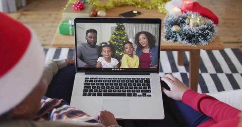 Virtual holiday video call connecting family across distance with laptop and cozy decor