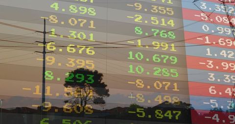 Digital stock market ticker overlay on suburban twilight skyline