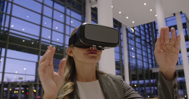 Businesswoman Using Virtual Reality Headset in Modern Office Building - Download Free Stock Images Pikwizard.com