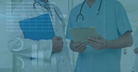 Medical team reviewing digital patient data on tablet with analytics overlays in hospital