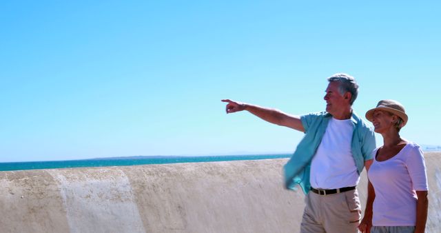 Senior Couple Enjoying Walk By The Sea On A Sunny Day - Download Free Stock Images Pikwizard.com