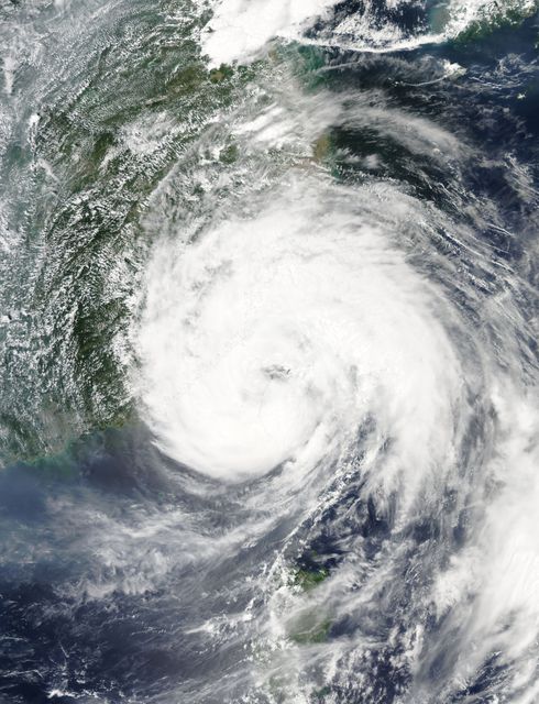 Taken on August 8, 2015, by NASA's Aqua Satellite, this image captures the eye of Typhoon Soudelor over northwestern Taiwan. The typhoon features maximum sustained winds of 90 knots and typhoon-force winds up to 35 miles from the center. This satellite image is useful for meteorologists, weather reports, educational material, and discussions on climate impacts and natural disasters.