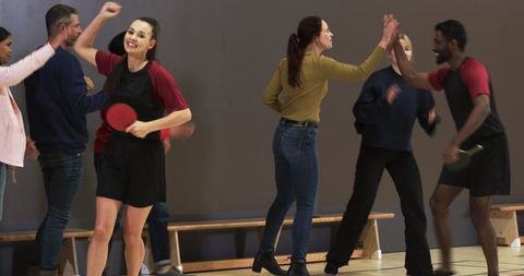 Diverse Team Celebrating Table Tennis Victory with High Five