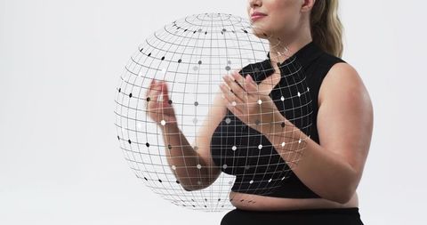 Holding holographic wireframe globe, presenting digital network sphere technology concept