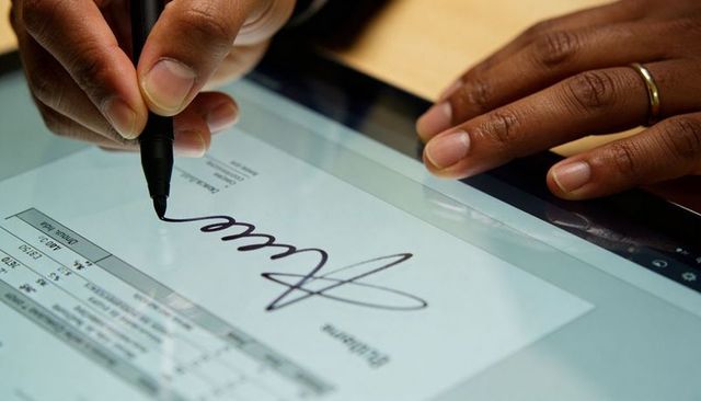 Signing Contract on Tablet with Stylus Close-Up Showing Digital Signature Process