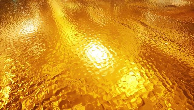 Golden rippled texture illuminated by warm light