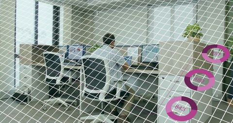 Office worker monitoring multiple screens with digital overlay