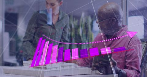 Diverse business team analyzing financial data displays